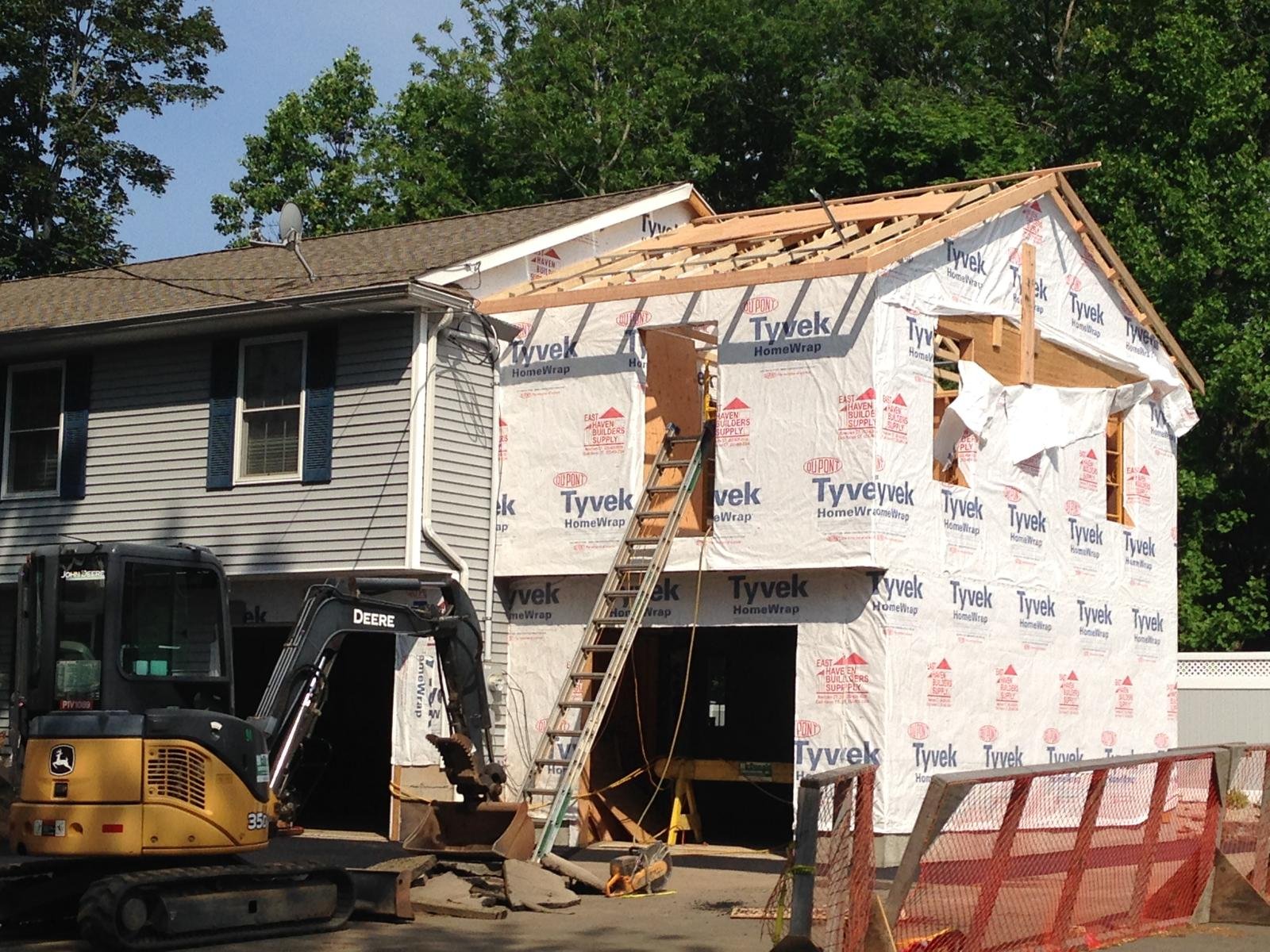 crew tearing off an old shingle roof, South Florida home