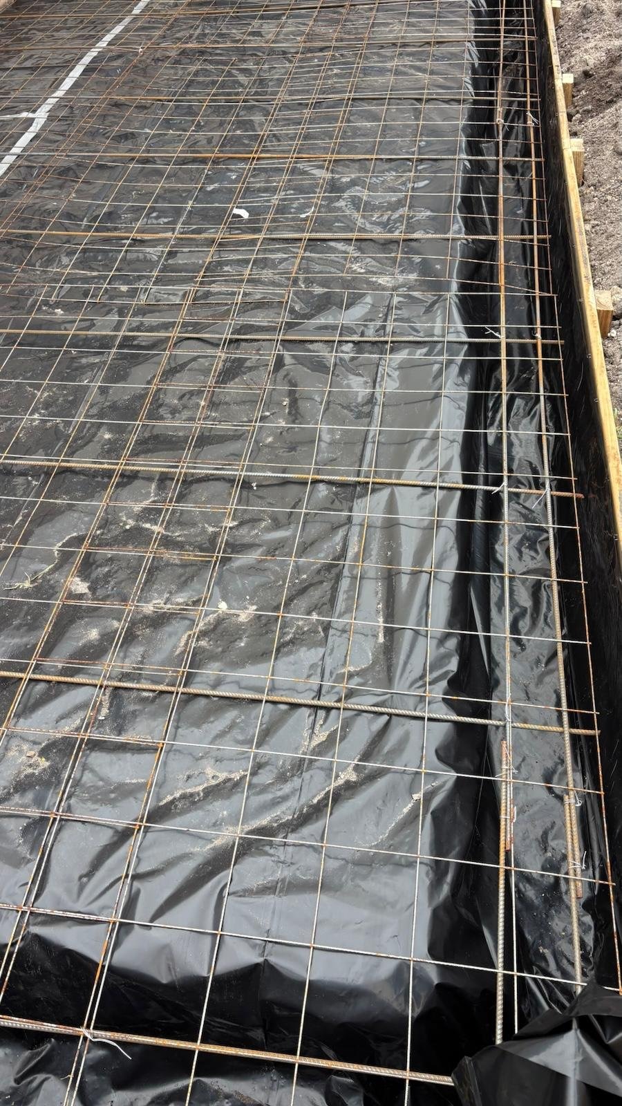 Slab preparation with rebar over vapor barrier โ the structural work underneath a commercial conversion