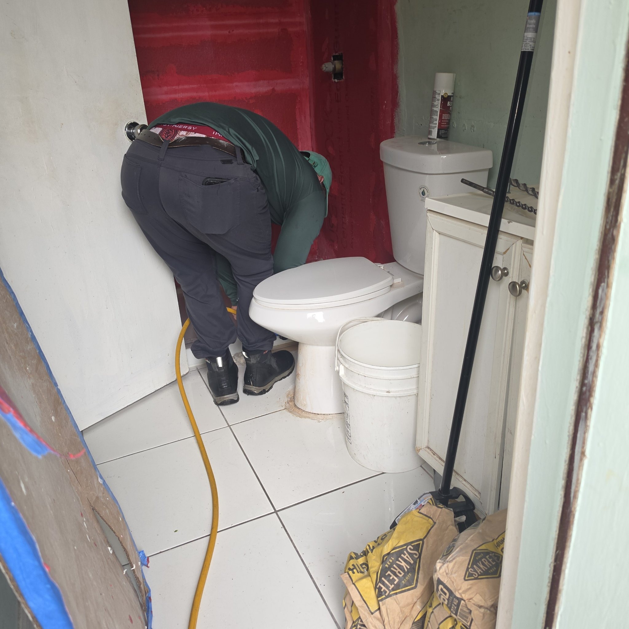 Onel Construction crew installing plumbing during a South Florida bathroom remodel